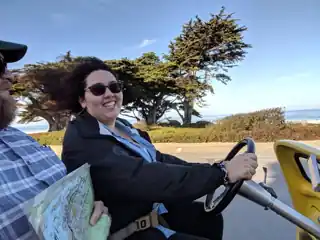 Laura and Bryce driving beside the coast.