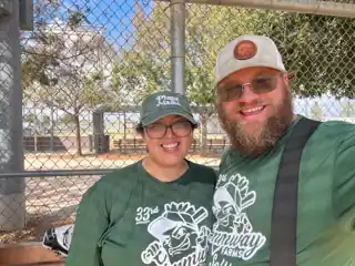 Laura and Bryce wearing matching green shirts.